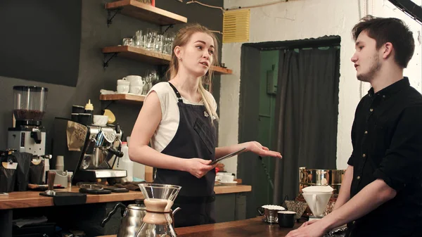 Mujer barista hablando con el cliente en un café, tomando el orden — Foto de Stock