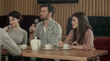 Bir grup genç insan mikrofona karaoke Kulüp partisinde şarkı