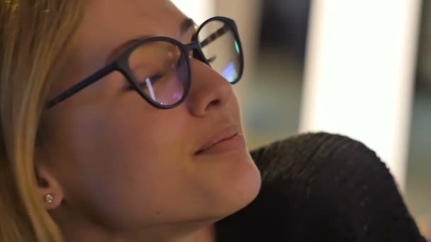 Sonriente chica joven en gafas geek mirando a la cámara — Vídeo de stock