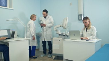 Tıp doktorları dizüstü ve tablet kullanarak office çalışma meşgul