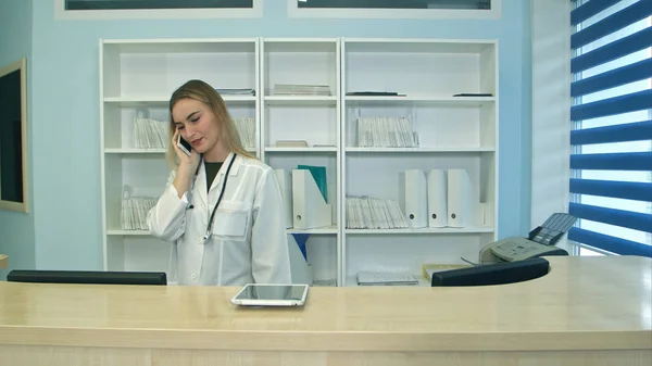 Telefon görüþmesi ve hasta randevuları zamanlama hastane resepsiyonda kadın hemşire