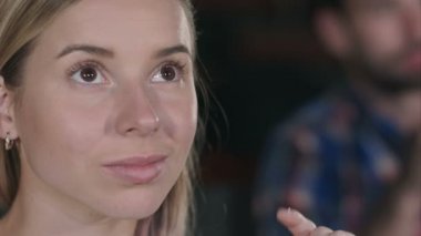 Bir film izlerken gülümseyen genç kadın