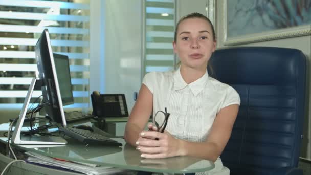 Bir kameraya konuşurken neşeli ofis asistanı — Stok video