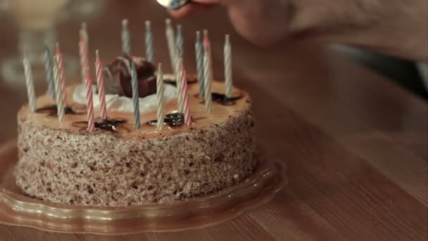 Male hand lighting candles in birthday cake — Stock Video