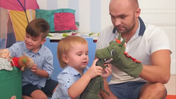 Parents heureux et deux petits garçons jouant avec des marionnettes — Video