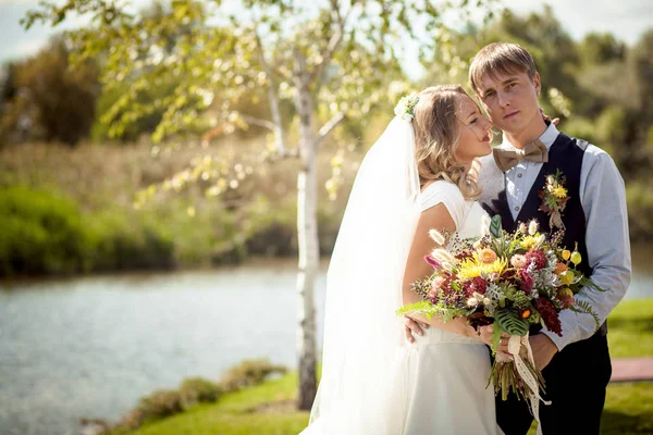 Flertando noiva com noivo perto lagoa — Fotografia de Stock
