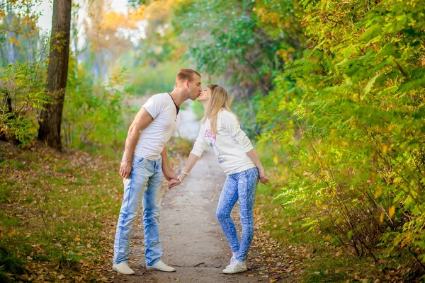 Husband with the pregnant wife lie on a grass — Stock Photo, Image