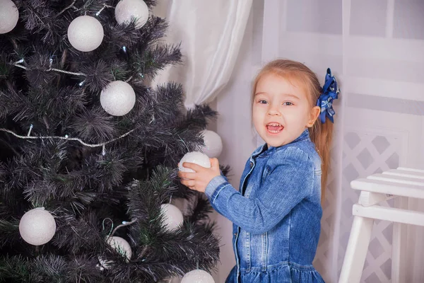 Meisje met giften in de buurt van een kerstboom thuis — Stockfoto