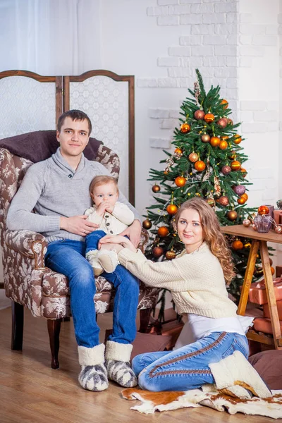 Happy family in jeans sitting xmas tree anticipation new year — Stock Photo, Image