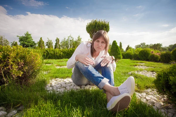 Cheerful girl in the park resting in trousers — Stock Photo, Image