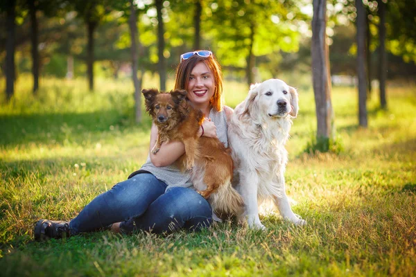Girl with dogs in the park — Stock Photo, Image