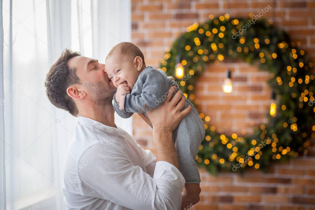 dad kisses his little son at home