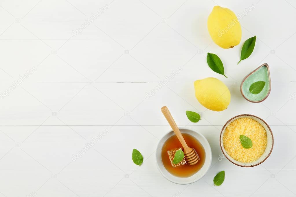 Homemade lemon salt bath and fresh honey in the plate with honey