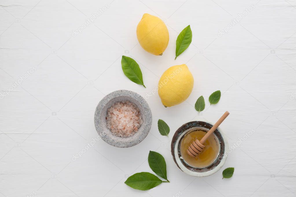 Homemade skincare concept, bath salt, lemon, honey dipper and mi