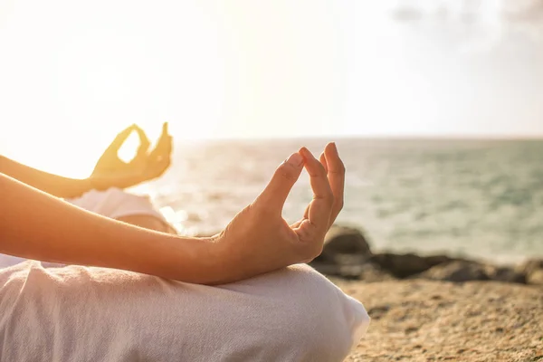 Young woman meditation yoga pose on tropical beach with sunlight — Stock Photo, Image