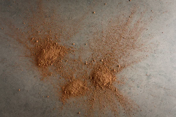 Pile cocoa powder on stone background from top view. — Stock Photo, Image