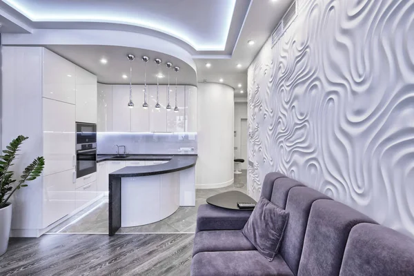 Modern design interior room with white gloss kitchen in a luxury apartment in gray and white tones.