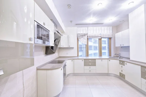 Modern design white kitchen in a spacious apartment.