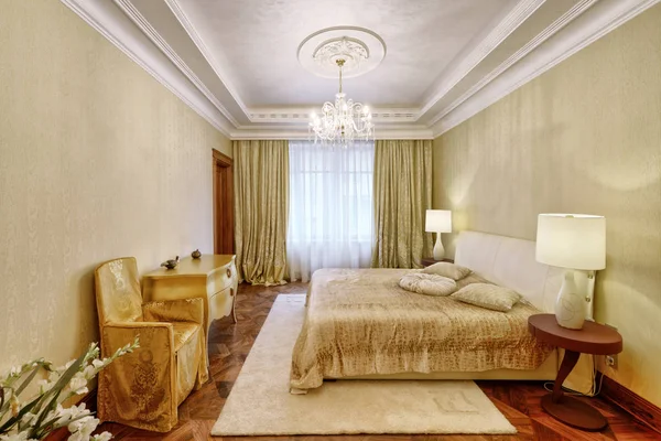 Designer modern renovation in a luxury house. Stylish bedroom interior with double bed.