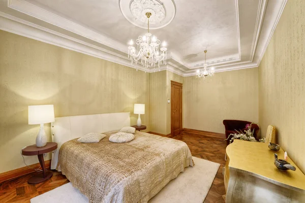 Designer modern renovation in a luxury house. Stylish bedroom interior with double bed.