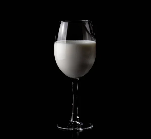 Glass of wine with milk on a black background