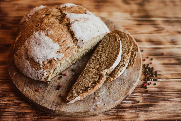 Grain Artisan Bread Loaf. Rustic loaf of homemade bread son dark wooden table. Homemade Loaf Of Bread with spices. Overhead view. Right place for the test