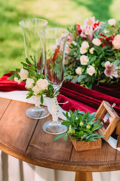Box for wedding rings decorated with flowers stand on a wooden table during a wedding ceremony. Wedding decorations. Closeup details of a wedding decor Wedding day. Outside