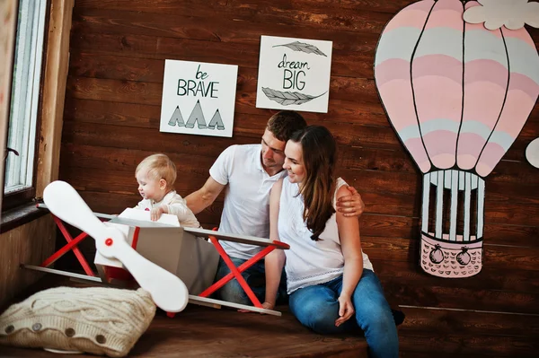 Young caucasian happy family with baby boy on decor plane with a — 스톡 사진