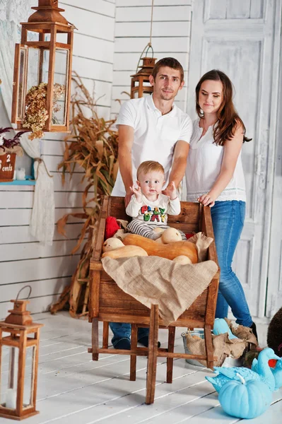 Young caucasian happy family in love background white wooden roo — Stockfoto
