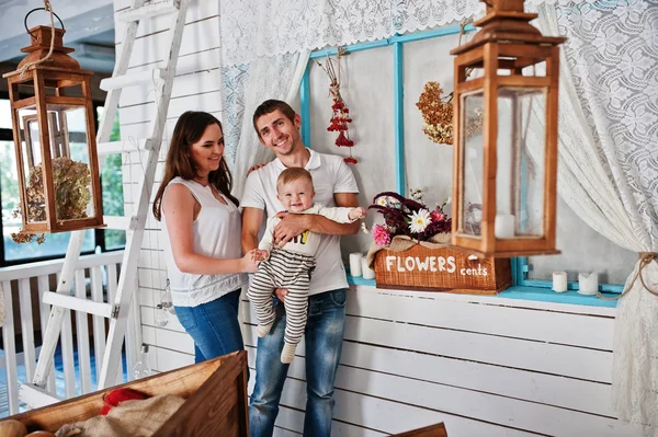 Young caucasian happy family in love background white wooden roo — 스톡 사진