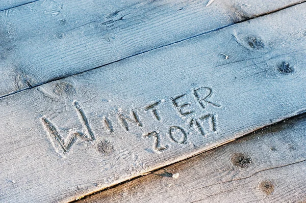 Winter 2017 written on a wooden background with frosts — Stock Photo, Image