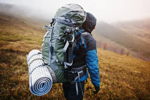 Close up view of back tourist backpack mats and tripod, wearing — Stock Photo, Image