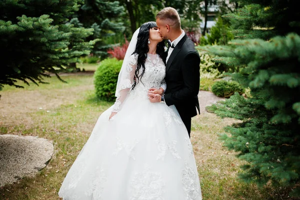 Glamourus couple de mariage embrassé sur le jardin de pins . — Photo