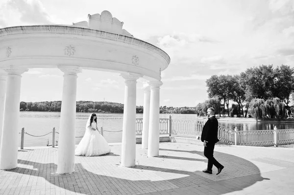 Herrliche Hochzeitspaar unter weißen Säulen Denkmal Hintergrund la — Stockfoto