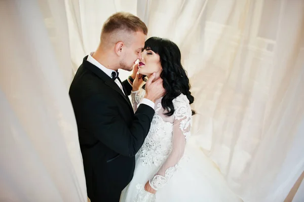 Casal de casamento elegante em cortinas no amor juntos . — Fotografia de Stock