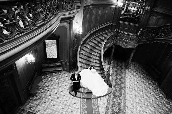 Charming wedding couple sitting on rich wooden stairs on great r — Stock Photo, Image