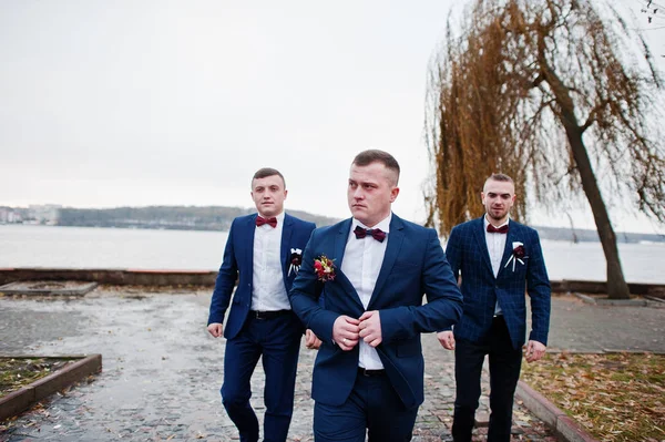 Groom with best mans at cold winter wedding day.