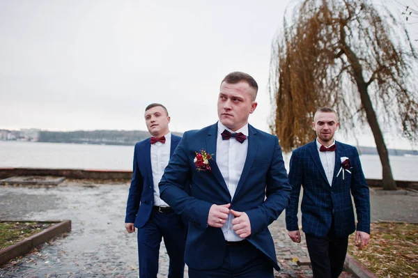 Groom with best mans at cold winter wedding day.