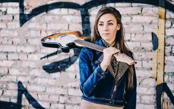 Jong meisje met een elektrische gitaar die het dragen van jeans jasje op abadon — Stockfoto