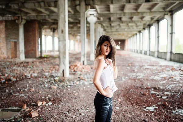 Portrait of young cute brunette girl wearing on black leather pa — Stock Photo, Image