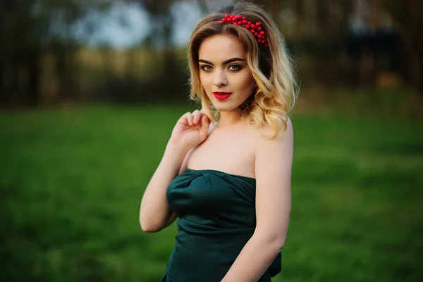 Yong Eleganz blondes Mädchen im grünen Kleid auf dem Garten im Frühling — Stockfoto