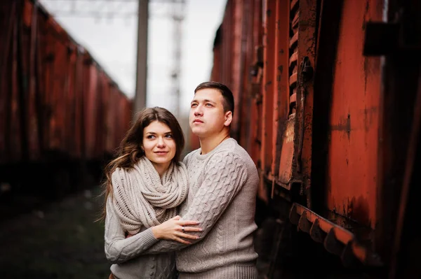 Young couple wearing on tied warm sweaters hugging in love at ra — Stock Photo, Image