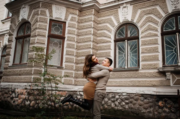 Young couple wearing on tied warm sweaters in love. Girl girl on — Stock Photo, Image