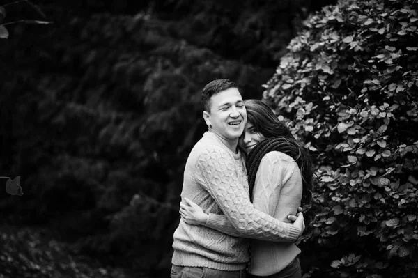 Young couple wearing on tied warm sweaters hugging in love at ci — Stock Photo, Image