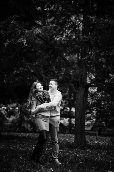 Young couple wearing on tied warm sweaters hugging in love at ci — Stock Photo, Image