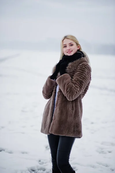 Retrato de chica rubia joven elegancia en un fondo abrigo de piel —  Fotos de Stock