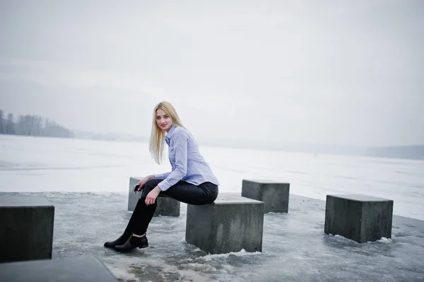 Stylish rich young blonde girl on blouse and leather pants with — Stock Photo, Image