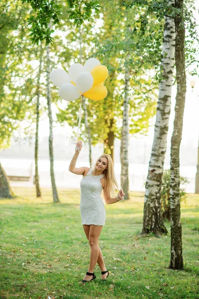 Portret van blond meisje dragen op witte jurk met ballonnen op — Stockfoto