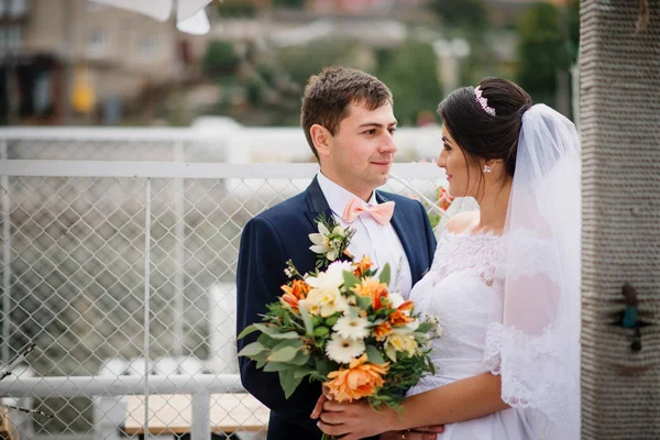 Matrimonio coppia soggiorno sul molo ormeggio al giorno nuvoloso . — Foto Stock