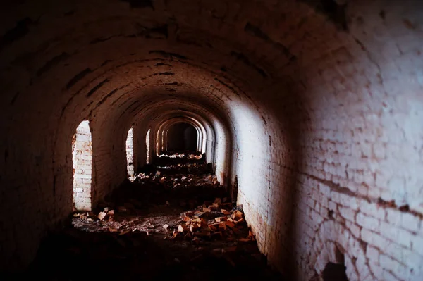 stock image Scary brick arch tunnel on dark and some light.